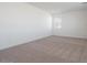 Spacious bedroom featuring neutral carpeting and bright lighting from a window at 40113 N Alameda Dr, San Tan Valley, AZ 85140