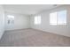 Bright bedroom featuring soft carpeting and abundant natural light from multiple windows at 40113 N Alameda Dr, San Tan Valley, AZ 85140