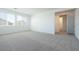 Bright bedroom featuring neutral carpeting and natural light from multiple windows at 40113 N Alameda Dr, San Tan Valley, AZ 85140