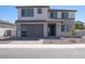 Inviting two-story home featuring a gray garage door, well-maintained gravel yard, and a modern architectural design at 40113 N Alameda Dr, San Tan Valley, AZ 85140