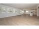 Bright living room with wood look tile floors and large windows providing ample natural light at 40113 N Alameda Dr, San Tan Valley, AZ 85140