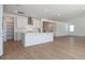 Open floor plan features a bright kitchen with an island, stainless vent hood, and view to staircase at 40113 N Alameda Dr, San Tan Valley, AZ 85140