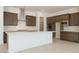 Bright kitchen featuring dark cabinetry, a white quartz island, and stainless steel appliances at 40129 N Alameda Dr, San Tan Valley, AZ 85140