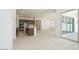 Modern kitchen with an island, stainless steel appliances, and an open floor plan with tile flooring at 40129 N Alameda Dr, San Tan Valley, AZ 85140