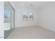 Bright room with tile floors, large sliding glass doors, and plenty of natural light at 40129 N Alameda Dr, San Tan Valley, AZ 85140