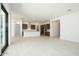 Bright and open living room featuring ceramic tile floors and seamless access to the kitchen at 40129 N Alameda Dr, San Tan Valley, AZ 85140