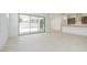 Bright living room with tile floors, a sliding glass door, and an open layout connected to the kitchen at 40129 N Alameda Dr, San Tan Valley, AZ 85140