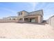 Spacious backyard with a covered patio and potential for landscaping and outdoor activities under a clear sky at 40147 N Alameda Dr, San Tan Valley, AZ 85140