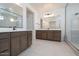 Modern bathroom featuring dual vanities, sleek countertops, and a glass-enclosed shower for a luxurious feel at 40147 N Alameda Dr, San Tan Valley, AZ 85140