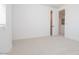 Bright bedroom showcases neutral carpeting and a window, creating a cozy and versatile space at 40147 N Alameda Dr, San Tan Valley, AZ 85140