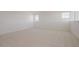 Spacious, carpeted bedroom with bright natural light coming in from two windows at 40147 N Alameda Dr, San Tan Valley, AZ 85140