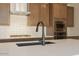 Close-up of kitchen with stainless appliances, stone countertops and sleek black faucet at 40147 N Alameda Dr, San Tan Valley, AZ 85140