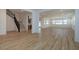 Open-concept living area with modern wood-look flooring, staircase, and kitchen access at 40147 N Alameda Dr, San Tan Valley, AZ 85140