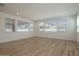 Bright living room featuring wood-look flooring and plenty of natural light at 40147 N Alameda Dr, San Tan Valley, AZ 85140