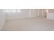 Large carpeted loft space with windows and entryways for an easy flow throughout the space at 40147 N Alameda Dr, San Tan Valley, AZ 85140