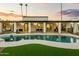 Resort-style backyard with a sparkling pool, covered patio, and lush landscaping at 4625 E Mountain View Rd, Phoenix, AZ 85028