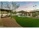 Beautiful backyard oasis with pool, covered patio, and manicured landscaping perfect for outdoor living at 4625 E Mountain View Rd, Phoenix, AZ 85028