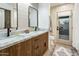 Bathroom with a double vanity, marble countertop, modern fixtures, and access to the outdoor patio at 4625 E Mountain View Rd, Phoenix, AZ 85028