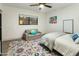 Bright bedroom with a colorful rug, a comfortable bed, a cozy loveseat, and plenty of natural light at 4625 E Mountain View Rd, Phoenix, AZ 85028