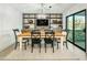 Dining room with wooden table, decorative shelving unit, a modern chandelier and natural light at 4625 E Mountain View Rd, Phoenix, AZ 85028
