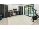 Home gym with exercise equipment, storage cabinets, and a sliding glass door leading to the pool area at 4625 E Mountain View Rd, Phoenix, AZ 85028