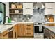 Modern kitchen with stainless steel appliances, granite countertops, and decorative backsplash at 4625 E Mountain View Rd, Phoenix, AZ 85028