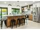 Modern kitchen featuring wood cabinets, stainless steel appliances, granite countertops, and a black framed window at 4625 E Mountain View Rd, Phoenix, AZ 85028