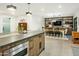 Bright kitchen featuring an island with a stone countertop and a dining area with stylish shelving and decor at 4625 E Mountain View Rd, Phoenix, AZ 85028