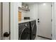 Laundry room with a washer and dryer, counter space, shelving, and sleek gray cabinetry at 4625 E Mountain View Rd, Phoenix, AZ 85028
