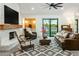 Cozy living area featuring fireplace, comfortable furniture, and large windows at 4625 E Mountain View Rd, Phoenix, AZ 85028