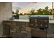 Stone outdoor grill area with stainless steel grill, sink, storage, and desert view at 4625 E Mountain View Rd, Phoenix, AZ 85028