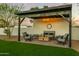 Charming outdoor living space featuring a covered patio with comfortable seating and stylish chandelier at 4625 E Mountain View Rd, Phoenix, AZ 85028