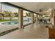 Inviting covered patio featuring a pool, dining area, ceiling fans, and rocky desert landscape at 4625 E Mountain View Rd, Phoenix, AZ 85028