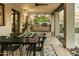 Outdoor dining area under a covered patio with a built-in grill and access to the home's interior at 4625 E Mountain View Rd, Phoenix, AZ 85028