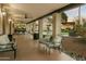 Spacious covered patio featuring comfortable seating, ceiling fans, and scenic views of the pool and backyard at 4625 E Mountain View Rd, Phoenix, AZ 85028