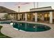 Stunning backyard pool reflecting the home's architecture and illuminated by landscape lighting at 4625 E Mountain View Rd, Phoenix, AZ 85028