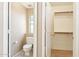 Well-lit half bathroom featuring a toilet, small window, adjacent closet and neutral wall color at 4693 W Tara Dr, Chandler, AZ 85226