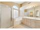 Bright bathroom with double sinks, a tub, a walk-in shower, and natural light from a large window at 4693 W Tara Dr, Chandler, AZ 85226