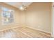 Cozy bedroom with wood floors, a ceiling fan, and a large window for natural light at 4693 W Tara Dr, Chandler, AZ 85226