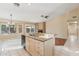 Kitchen with a kitchen island, granite countertops, stainless steel appliances, and a view of the breakfast nook at 4693 W Tara Dr, Chandler, AZ 85226