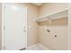 Practical laundry area with overhead shelving and tiled flooring at 4693 W Tara Dr, Chandler, AZ 85226