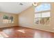 Bright living room with vaulted ceilings, multiple windows, and sleek wood floors, providing ample natural light at 4693 W Tara Dr, Chandler, AZ 85226