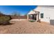 Wide view of the home's private backyard with gravel landscaping and a covered patio with seating at 5101 E Sharbel Rd, San Tan Valley, AZ 85143