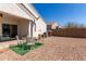 Backyard featuring a wrought iron patio set and low-maintenance gravel landscaping at 5101 E Sharbel Rd, San Tan Valley, AZ 85143