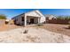 Expansive backyard with low-maintenance gravel landscaping, block wall, and covered patio with grill at 5101 E Sharbel Rd, San Tan Valley, AZ 85143