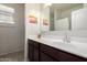 Bathroom sink with white countertop, dark cabinet, and decorative artwork on the walls at 5101 E Sharbel Rd, San Tan Valley, AZ 85143