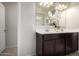 Bathroom with a double vanity, dark cabinets, white countertop, and decorative floral arrangement at 5101 E Sharbel Rd, San Tan Valley, AZ 85143