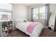 Bright bedroom with plush carpet, large windows, and a cozy bed with a pink blanket at 5101 E Sharbel Rd, San Tan Valley, AZ 85143