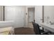 Bright bedroom with plush carpet, white sliding closet door, and a clean desk at 5101 E Sharbel Rd, San Tan Valley, AZ 85143