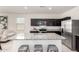 Bright kitchen featuring stainless steel appliances, dark cabinets, and granite countertop island at 5101 E Sharbel Rd, San Tan Valley, AZ 85143